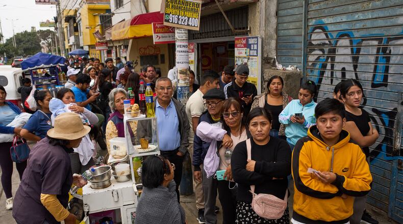 People line up to collect their national identity cards ahead of Peru's presidential runoff election in Lima, Peru, Saturday, June 6, 2026. (AP Photo/Rodrigo Abd)