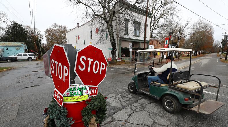 120821 Rutledge: A local resident navigates the 4-way stop on East Main Street in historic downtown Rutledge on his way to the Caboose on Wednesday, Dec 8, 2021. Ed Hogan, owner of the Caboose restaurant, is opposed to the Rivian GA electric vehicle plant saying "it's going to be too many vehicles. There will be 200 cars out here. I don't know what other people want but we like it the way it is" . “Curtis Compton / Curtis.Compton@ajc.com”`