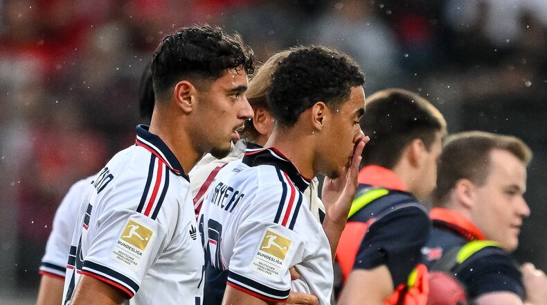 Bayern's Jamal Musiala, second left, leaves the field during a friendly soccer match between FC Heidenheim and FC Bayern Munich in Heidenheim, Germany, Tuesday, Aug. 18, 2026. (Harry Langer/DeFodi/dpa via AP)