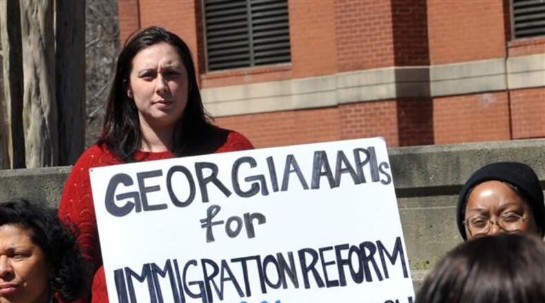 MARCH 26, 2014 ATLANTA Maria Adams with the Asian American Legal Advocacy Center holds a sign during the event. Demonstrators with the "Fast for Families Across America" tour arrive at the MLK Jr. Historic Site in Atlanta Wednesday, March 26, 2014. Demonstrators who drew national attention last year for fasting on the National Mall in support of a congressional overhaul of the immigration system brought their campaign to Atlanta Wednesday. Among them is Eliseo Medina, a former international secretary-treasurer of the Service Employees International Union. He is part of the "Fast for Families Across America" campaign that is touring congressional districts nationwide. KENT D. JOHNSON / KDJOHNSON@AJC.COM Dropping illegal immigrants off at bus stations in another state is probably not the type of reform she was asking for.