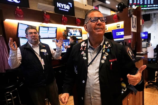 Traders Jonathan Mueller, right, and Michael Capolino work on the floor of the New York Stock Exchange, Wednesday, May 14, 2025. (AP Photo/Richard Drew)