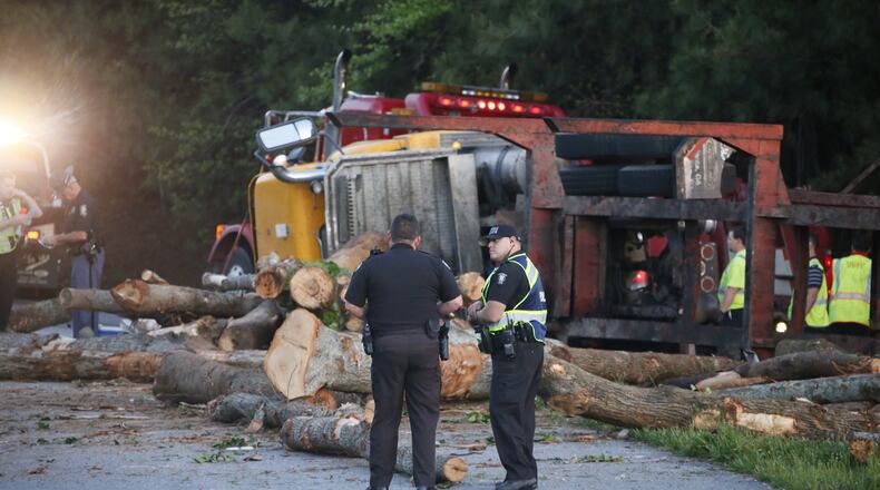 A truck overturned and dumped a load of logs onto the ramp from Peachtree Industrial Boulevard to I-285 westbound on Monday, April 21, 2014.