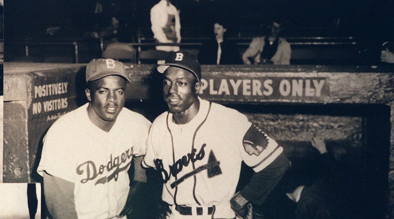 A copy of a photo from the Braves Museum at Turner Field of Jackie Robinson, left, with Sam "Jet" Jethro, the first African American to play for the Braves, joining the team in 1950. (Taimy Alvarez/The Atlanta Journal-Constitution)