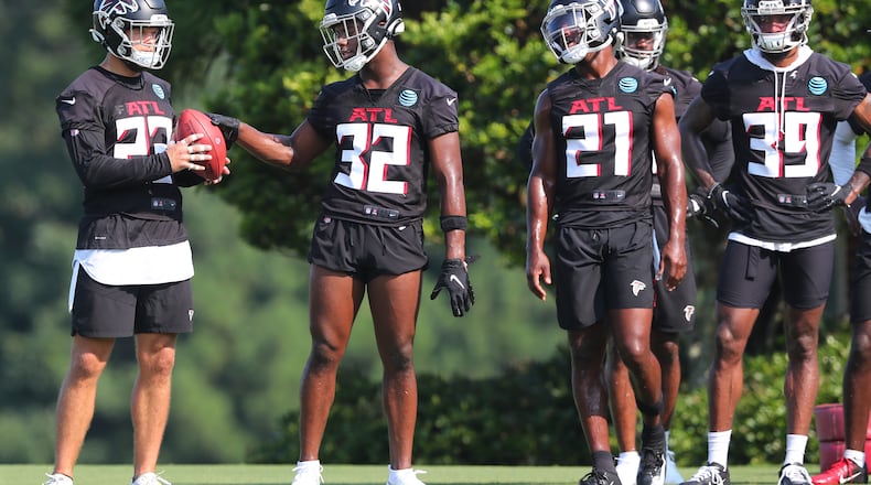 072921 Flowery Branch: Atlanta Falcons safeties Erik Harris (from left), Jaylinn Hawkins, Duron Harmon and T.J. Green prepare to run defensive drills during the first day of training camp practice at the team training facility on Thursday, July 29, 2021, in Flowery Branch. “Curtis Compton / Curtis.Compton@ajc.com”