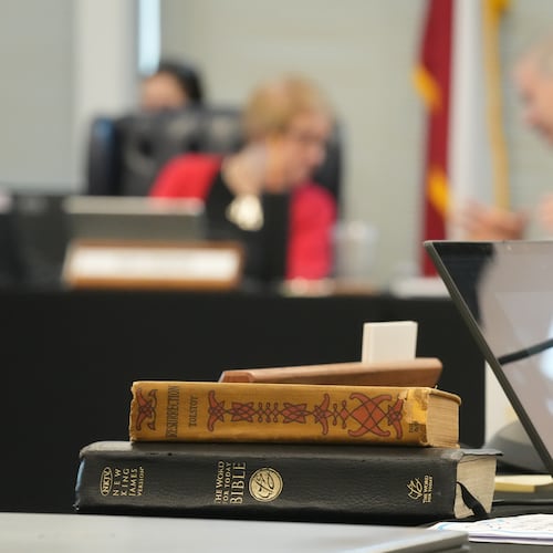 A Bible and Resurrection by Leo Tolstoy sit on the desk of State Board of Education member LJ Francis during a meeting on proposed social studies standards at the Barbara Jordan Building in Austin on Monday, June 22, 2026. (Jay Janner/Austin American-Statesman via AP)