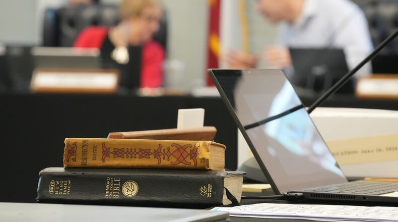 A Bible and Resurrection by Leo Tolstoy sit on the desk of State Board of Education member LJ Francis during a meeting on proposed social studies standards at the Barbara Jordan Building in Austin on Monday, June 22, 2026. (Jay Janner/Austin American-Statesman via AP)