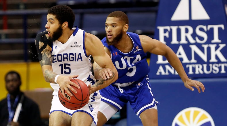 Georgia State guard D'Marcus Simonds (23) is defended by Texas-Arlington guard Edric Dennis (5) during the first half of the Sun Belt Conference men's tournament final Sunday, March 17, 2019, in New Orleans.