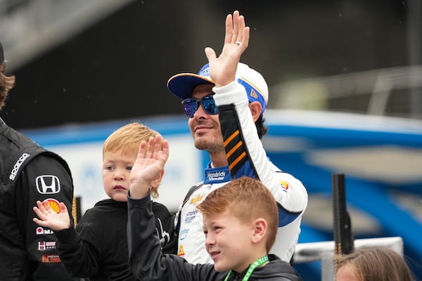 Kyle Larson waves as he's introduced before the start of the Indianapolis 500 auto race at Indianapolis Motor Speedway in Indianapolis, Sunday, May 25, 2025. (AP Photo/AJ Mast)