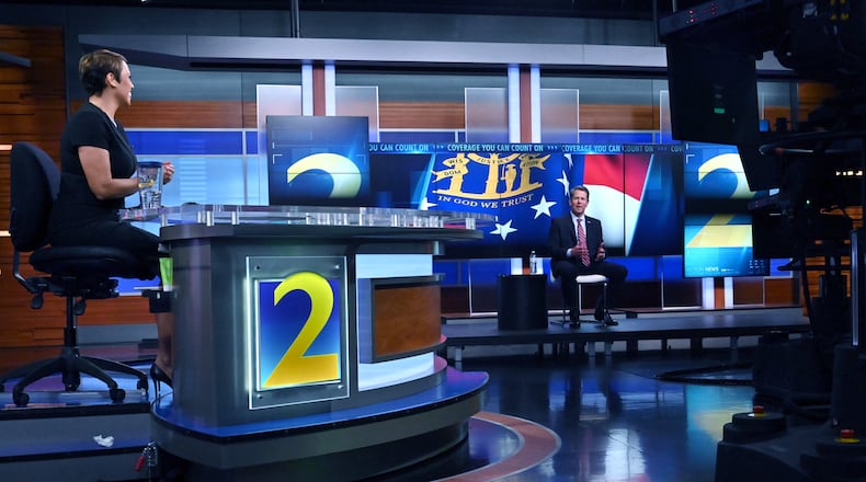 March 26, 2020 Atlanta - For social distancing, Channel 2 Action News Anchor Jovita Moore and Gov. Brian Kemp sit afar off during a town hall meeting to discuss the growing coronavirus pandemic that airs live on WSB-TV Channel 2, CBS46, Georgia Public Broadcasting, 11 Alive, FOX 5 Atlanta and Univision 34 Atlanta at WSB-TV Channel 2 on Thursday night, March 26, 2020. (Hyosub Shin / Hyosub.Shin@ajc.com)