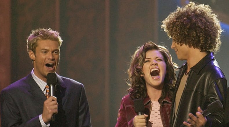 Ryan Seacrest bestowing the first "American Idol" crown in August, 2002 to Kelly Clarkson over Justin Guarini. CREDIT: Fox
