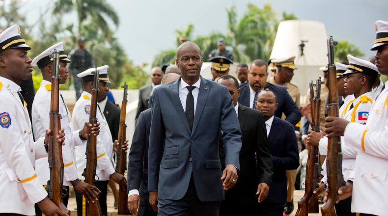 FILE - Haiti's President Jovenel Moise, center, leaves the museum during a ceremony marking the 215th anniversary of revolutionary hero Toussaint Louverture's death, at the National Pantheon museum in Port-au-Prince, Haiti, April 7, 2018. (AP Photo/Dieu Nalio Chery, File)