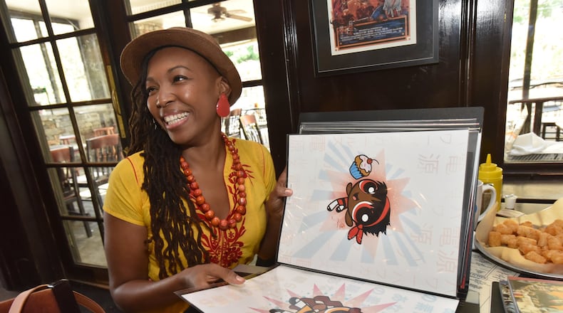 Comic book artist Afua Richardson, the illustrator on John Lewis’ new graphic novel “Run,” shows off her puckish version of the Power Puff Girls. (She turns the superheroes into girls of color and calls them Cocoa Puff Girls.) HYOSUB SHIN / HSHIN@AJC.COM
