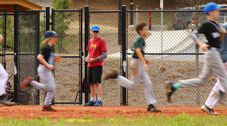 032515 ATLANTA: Assistant baseball coach Mark Davis has the Atlanta Neighborhood Charter School Wolves baseball team running sprints during team practice on Wednesday, March 25, 2015, in Atlanta. Curtis Compton / ccompton@ajc.com