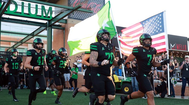 FILE - North Texas offensive lineman Tay Yanta II (70) and North Texas linebacker Shane Whitter (7) lead the team onto the field before an NCAA college football game against South Florida Oct. 10, 2025, in Denton, Texas. (AP Photo/Richard W. Rodriguez, File)