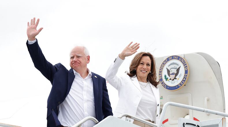 US Vice President and 2024 Democratic presidential candidate Kamala Harris and her running mate Minnesota Governor Tim Walz wave as they board Air Force Two, departing Chippewa Valley Regional Airport in Eau Claire, Wisconsin on Aug. 7, 2024. (Kamil Krzaczynski/AFP via Getty Images/TNS)