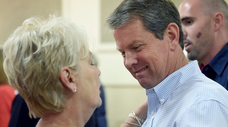 GOP candidate for governor Brian Kemp (right) chats with supporter at the Ocilla, Ga., Community House earlier this month. RYON HORNE / RHORNE@AJC.COM
