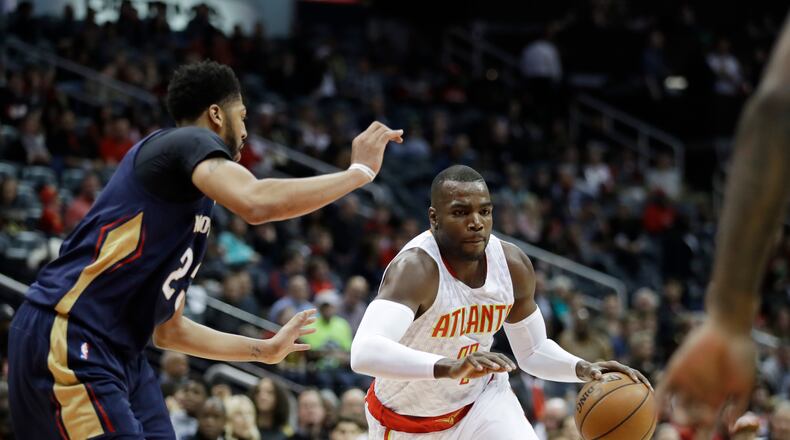 Atlanta Hawks’ Paul Millsap, right, plays against New Orleans Pelicans’ Anthony Davis (23) in the first quarter of an NBA basketball game in Atlanta, Tuesday, Nov. 22, 2016. (AP Photo/David Goldman)