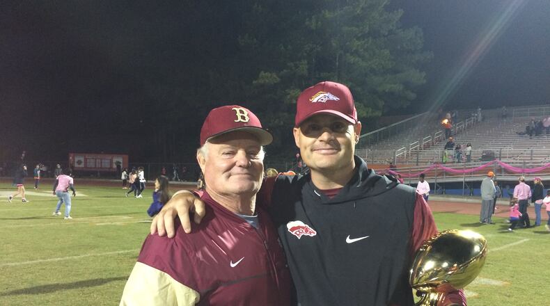 Brookwood coach Philip Jones (right) celebrates the win over Parkview with his father, former Brookwood assistant Tom Jones.