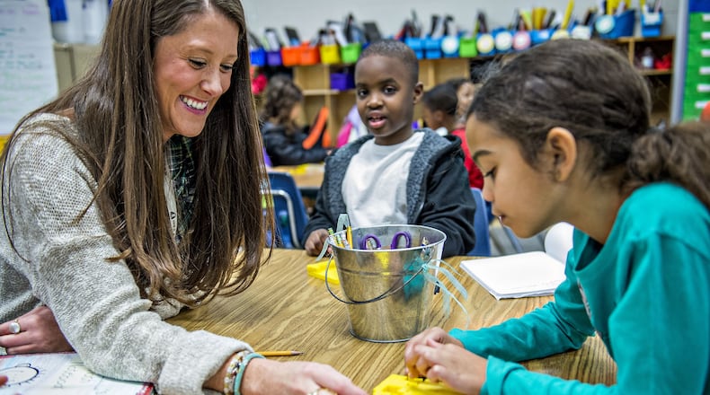 January 22, 2016 Snellville - First grade teacher Christine Ross (left) helps Aryn Scarabin with a math problem during class at Centerville Elementary School in Snellville on Friday, January 22, 2016. Gov. Nathan Deal praised Gwinnett County Public Schools in his State of the State address this month for developing a teacher compensation model that "rewards effectiveness, promotes flexibility and requires accountability."
 JONATHAN PHILLIPS / SPECIAL