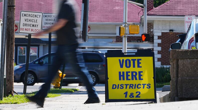 A person walks from a polling place for the New Jersey primary election in Oaklyn, N.J., Tuesday, June 2, 2026. (AP Photo/Matt Rourke)