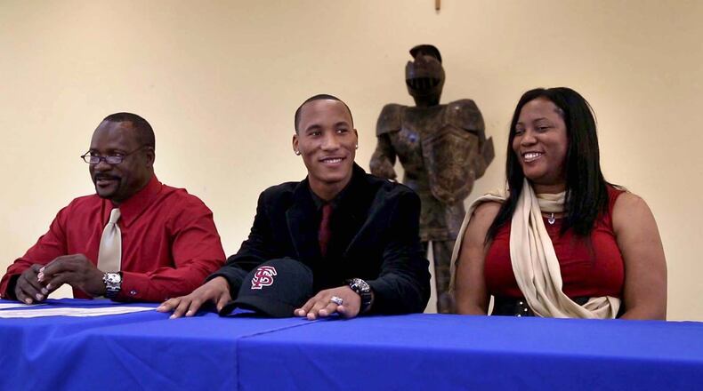 Cardinal Newman wide receiver Travis Rudolph with his parents Darryl and Linda Rudolph after signing with Florida State University on national signing day in West Palm Beach, Florida on February 5, 2014. (Allen Eyestone/The Palm Beach Post)