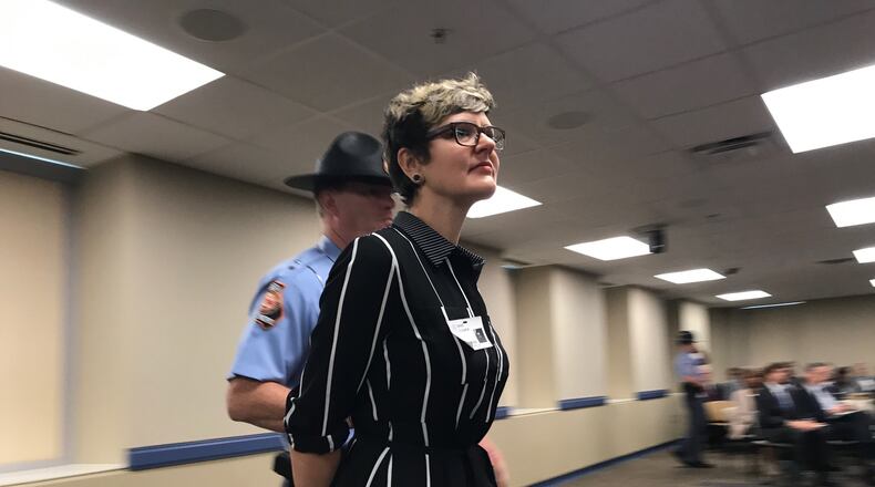 Demonstrator Eleanor Davis is removed from the May 16, 2017 Georgia Board of Regents meeting for protesting the University System of Georgia's admissions policy toward those without legal status. ERIC STIRGUS/ESTIRGUS@AJC.COM