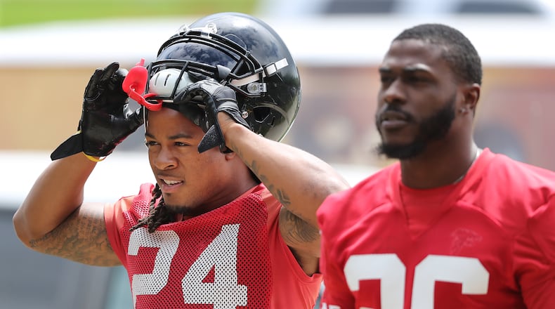May 22, 2018 Flowery Branch: Atlanta Falcons running backs Devonta Freeman (left) and Tevin Coleman arrive for organized team activities on Tuesday, May 22, 2018, in Flowery Branch.   Curtis Compton/ccompton@ajc.com