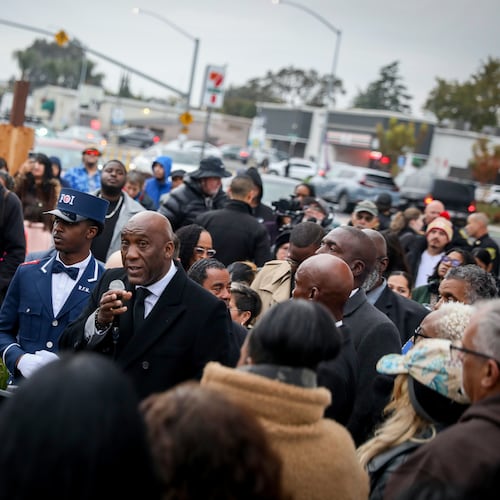 Nuri Muhammad speaks to people gathered at a vigil near the site where a mass shooting took place Saturday at a banquet hall in Stockton, Calif., Sunday, Nov. 30, 2025. (Brontë Wittpenn/San Francisco Chronicle via AP)