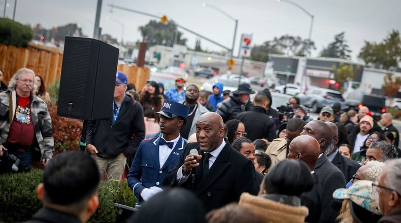 Nuri Muhammad speaks to people gathered at a vigil near the site where a mass shooting took place Saturday at a banquet hall in Stockton, Calif., Sunday, Nov. 30, 2025. (Brontë Wittpenn/San Francisco Chronicle via AP)