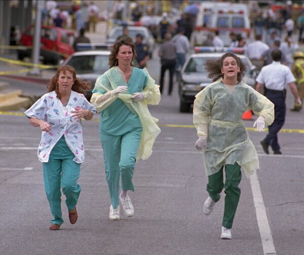 FILE - Medical assistants Janet Froehlich, Wilma Jackson and Kerri Albright run from the Alfred P. Murrah Federal Building after being told another bomb device had been found on April 19, 1995, in Oklahoma City. (AP Photo/David J. Phillip, File)