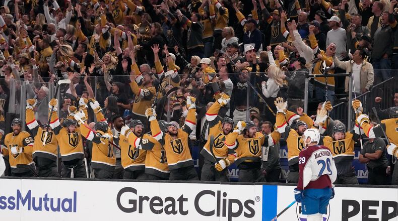 Members of the against the Vegas Golden Knights celebrate an empty net goal by Brett Howden as Colorado Avalanche center Nathan MacKinnon skates by during the third period in Game 3 of the Western Conference finals NHL hockey Stanley Cup playoff series Sunday, May 24, 2026, in Las Vegas. (AP Photo/Mark J. Terrill)