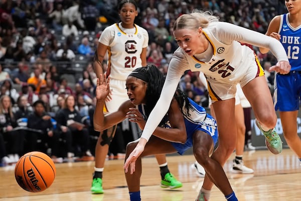 South Carolina forward Chloe Kitts (21) and Duke guard Oluchi Okananwa chase a ball out of bounds during the first half in the Elite Eight of the NCAA college basketball tournament, Sunday, March 30, 2025. in Birmingham, Ala. (AP Photo/Gerald Herbert)
