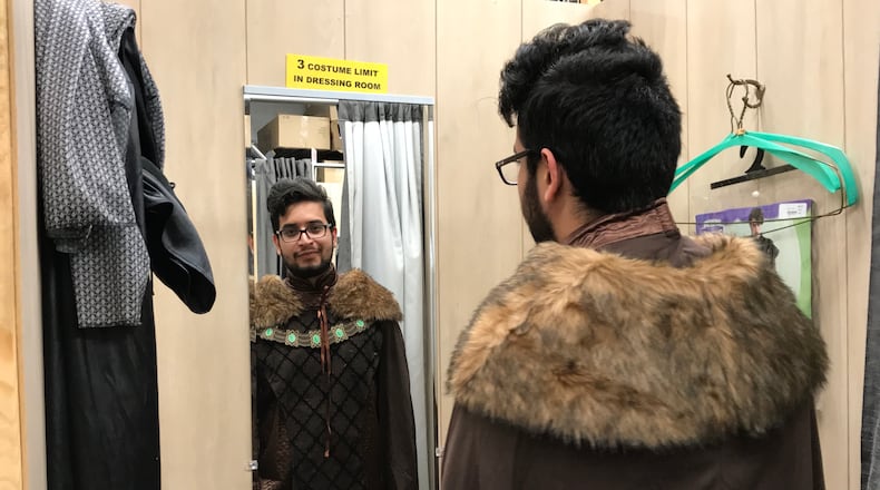 Daniel Brito tries on a costume as the "Forest Prince" for this weekend's annual Dragon Con Convention. An insurance salesman by day, Brito goes to Dragon Con for the networking and concerts. CREDIT: SHELIA POOLE
