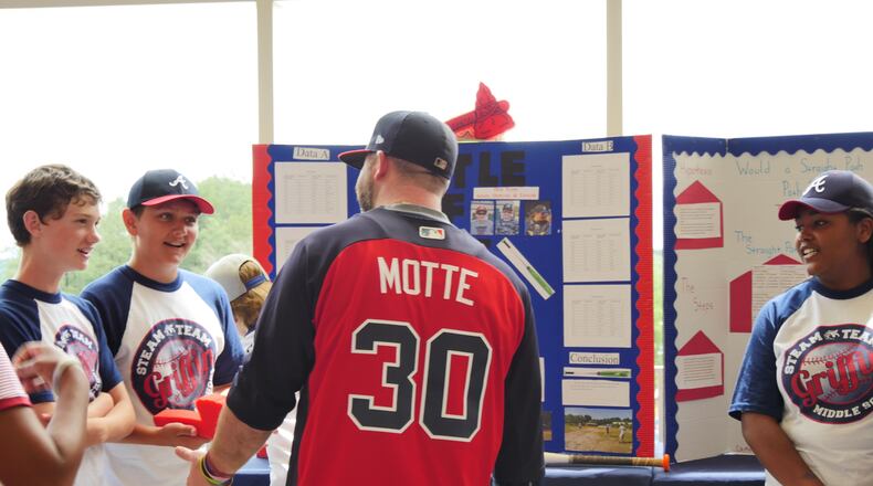 Braves relief pitcher Jason Motte talks with Griffin Middle schoolers (l to r) Aidan Daily, Taylor Daxe and Caitlynn Campbell and their Science of Baseball project. Credit: Richard Morris.
