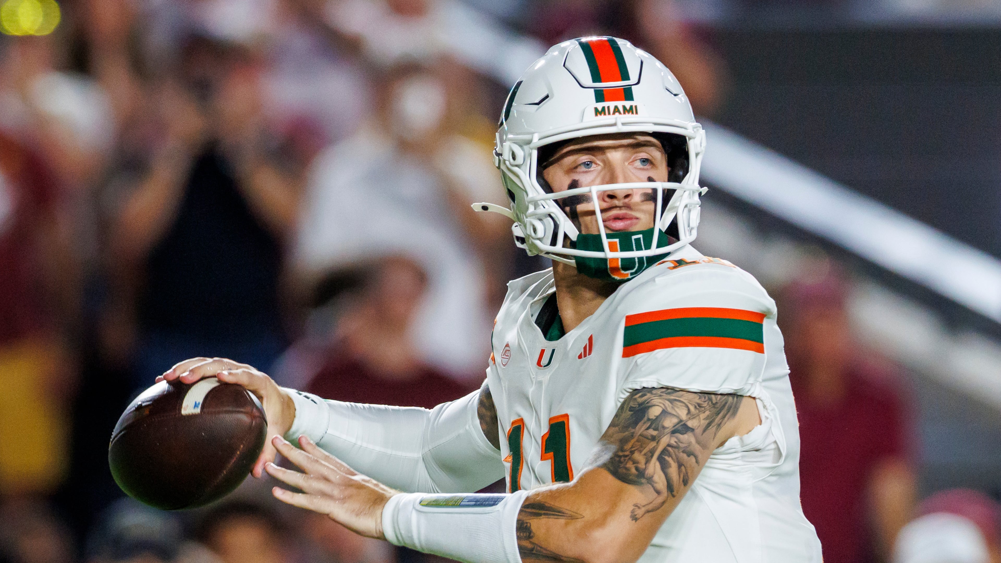 Miami quarterback Carson Beck (11), who transferred from Georgia, looks for a receiver during the first half of an NCAA college football game against Florida State, Saturday, Oct. 4, 2025, in Tallahassee, Fla. (AP Photo/Colin Hackley)