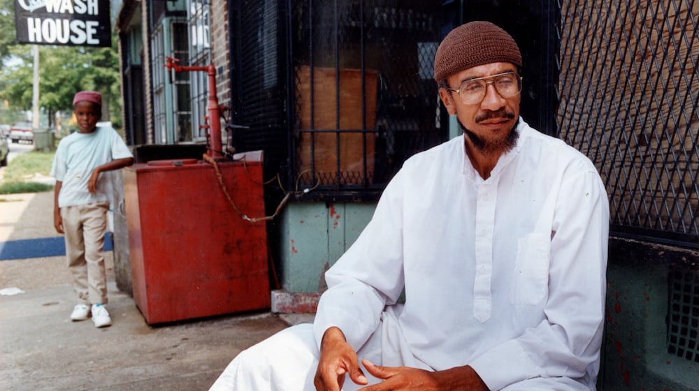 Imam Jamil Abdullah Al-Amin, the former H. Rap Brown, in front of his West End Community grocery store on Oak Street in 1990. (Kathryn Kolb/AJC file)