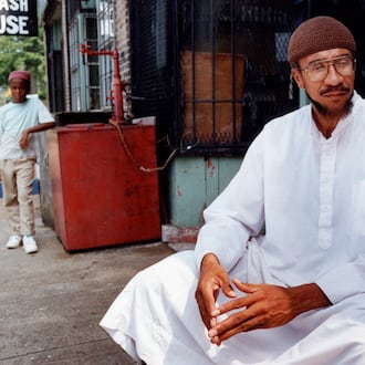 Imam Jamil Abdullah Al-Amin, the former H. Rap Brown, in front of his West End Community grocery store on Oak Street in 1990. (Kathryn Kolb/AJC file)