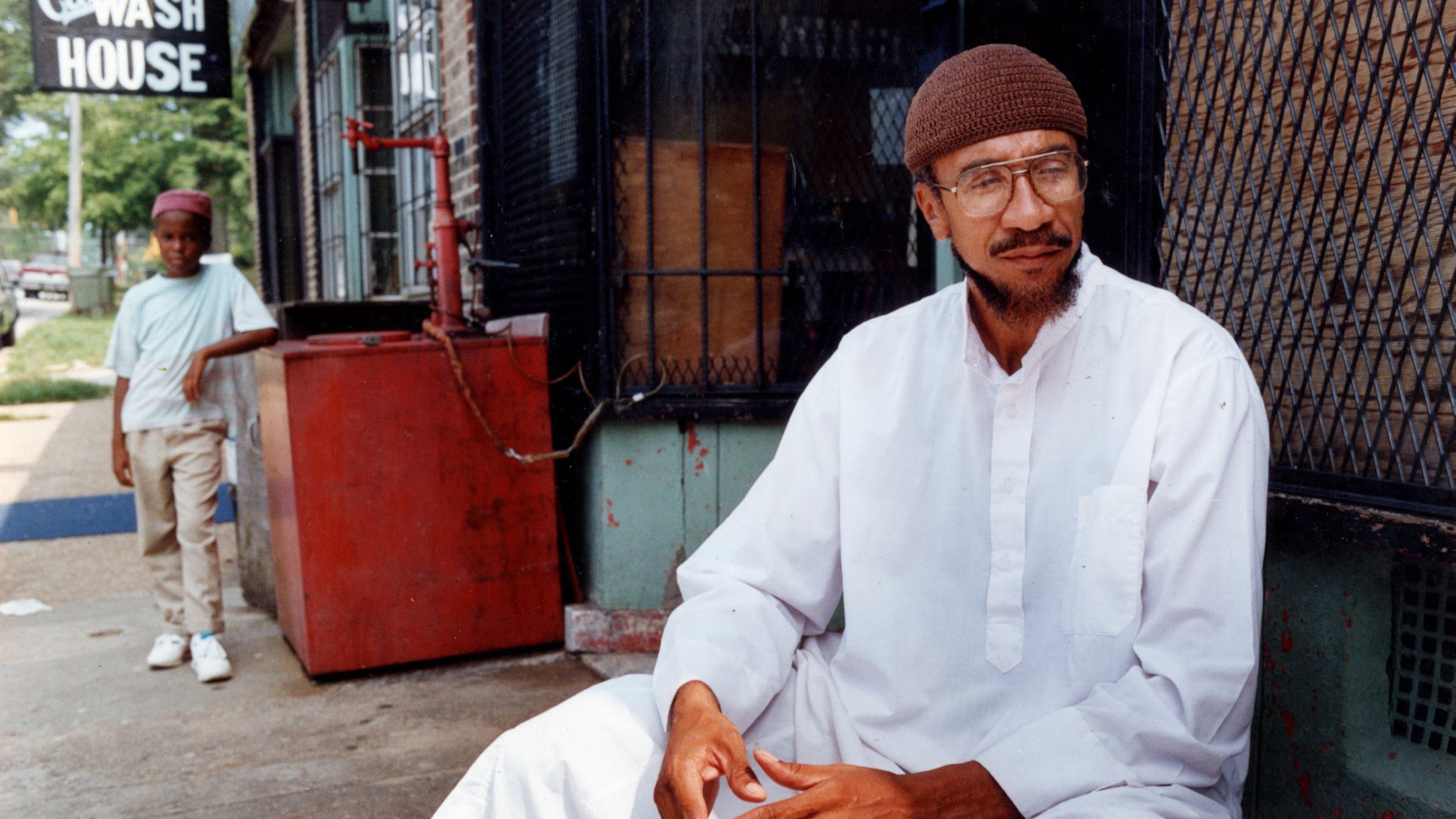 Imam Jamil Abdullah Al-Amin, the former H. Rap Brown, in front of his West End Community grocery store on Oak Street in 1990. (Kathryn Kolb/AJC file)