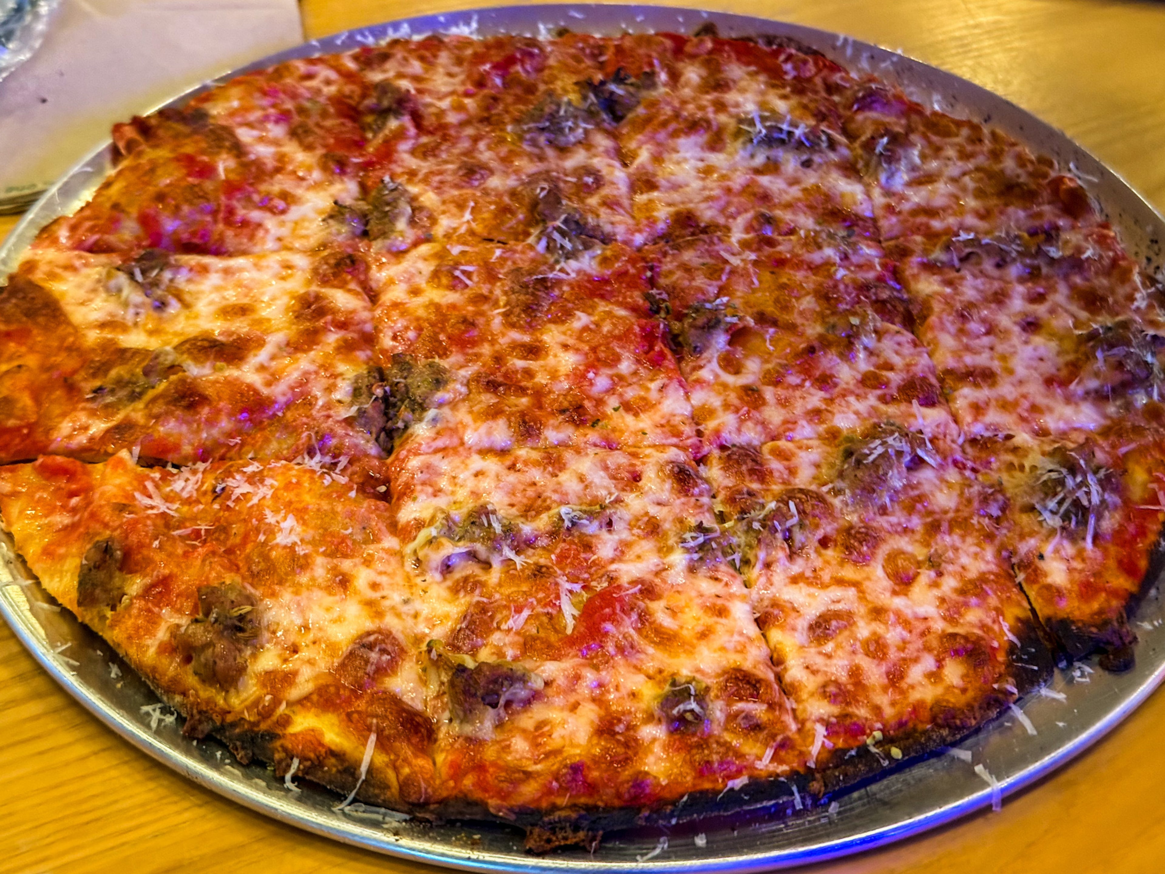 Bar pie at Brainwave Pizza is characterized by its cracker-thin crust. (Henri Hollis/AJC)