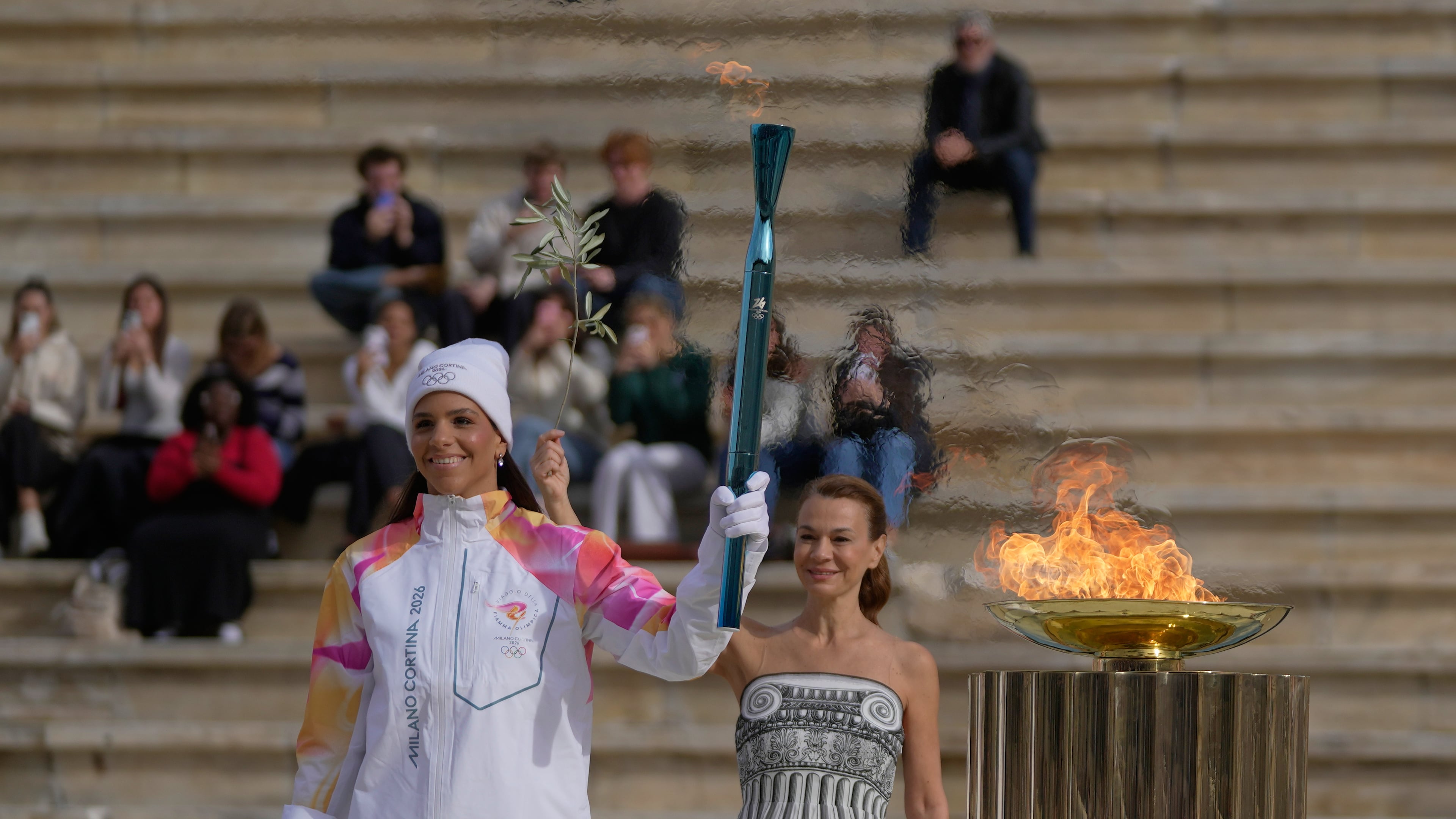 Greek Women's National Water polo player Elena Xenaki lights the cauldron during the Olympic flame handover ceremony for the Milan Cortina 2026 Winter Olympics at Panathenaic stadium, in Athens, Greece, Thursday, Dec. 4, 2025. (AP Photo/Thanassis Stavrakis)
