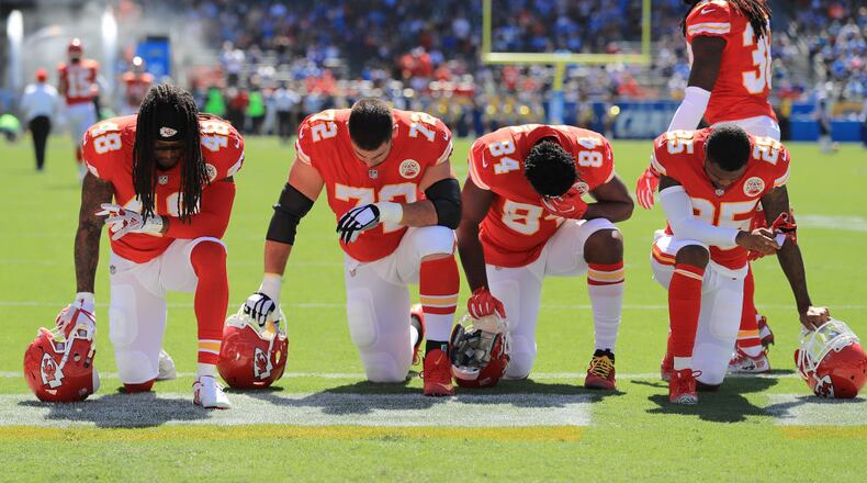 CARSON, CA - SEPTEMBER 24:  Terrance Smith #48, Eric Fisher #72, Demetrius Harris #84, and Cameron Erving #75 of the Kansas City Chiefs is seen taking a knee before the game against the Los Angeles Chargers at the StubHub Center on September 24, 2017 in Carson, California.  (Photo by Sean M. Haffey/Getty Images)