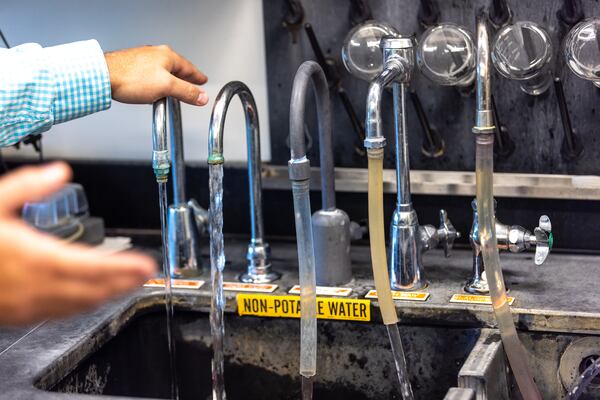 Coty McDaniel, water production director for the Clayton County Water Authority, shows sampling points for testing water at the Terry R. Hicks Water Production Plant in Jonesboro in 2023. (Arvin Temkar/AJC)