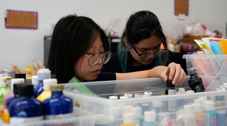Shoppers look through art supplies for sale at the Brooklyn Creative Reuse on Wednesday, July 29, 2026, in the Brooklyn borough of New York. (AP Photo/Alyssa Goodman)