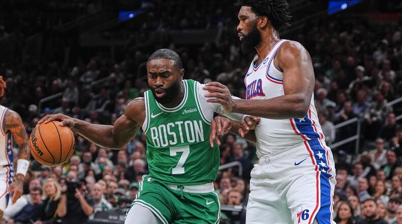 FILE - Boston Celtics forward Jaylen Brown (7) drives to the basket against Philadelphia 76ers center Joel Embiid, right, during the first half of an NBA basketball game, Wednesday, Oct. 22, 2025, in Boston. (AP Photo/Charles Krupa,File)