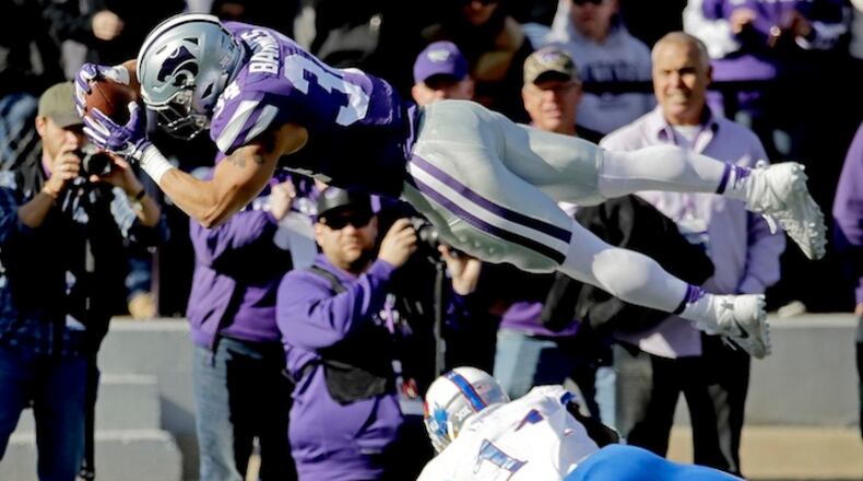 FILE - In this Nov. 26, 2016, file photo, Kansas State running back Alex Barnes (34) dives into the end zone over Kansas linebacker Mike Lee (11) to score a touchdown during the first half of an NCAA college football game, in Manhattan, Kan. After beginning last season buried on the depth chart, Barnes wound up rushing for 442 yards and six touchdowns on just 56 carries. That was good enough for second in school history in both categories by a freshman running back. (AP Photo/Charlie Riedel, File)