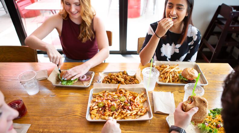 Customers dine on burgers and share pimento cheese fries and fried pickles at LR Burger. Courtesy of Damian AhChing/Local Restaurant Group