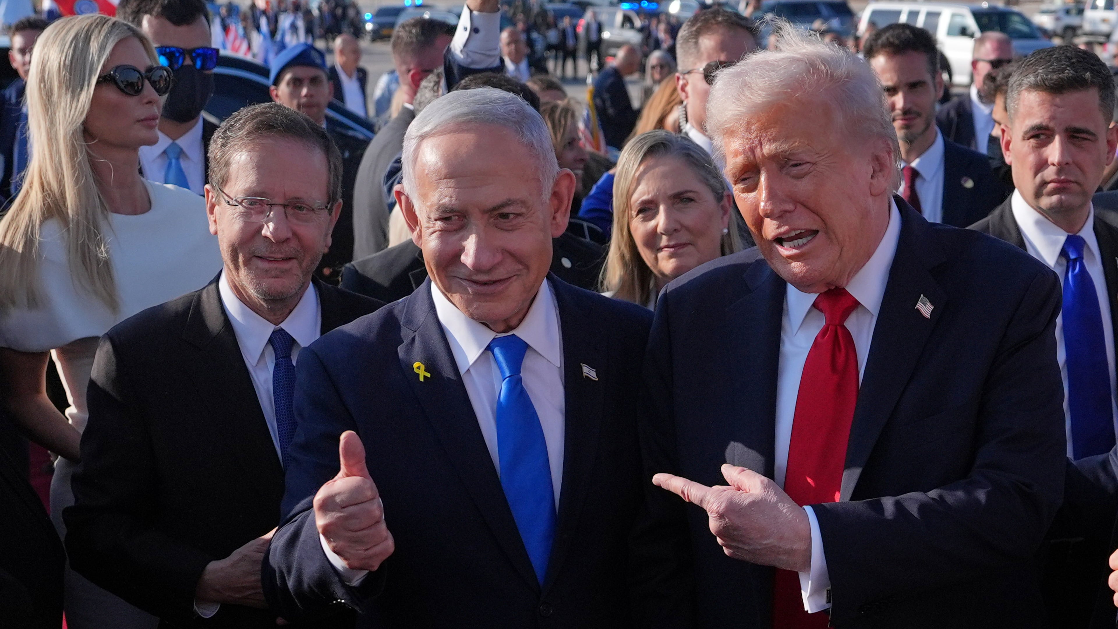 President Donald Trump poses for a photo with Israel's Prime Minister Benjamin Netanyahu before he boards Air Force One at Ben Gurion International Airport, Monday, Oct. 13, 2025, near Tel Aviv, as Israel's President Isaac Herzog, left, watches. (AP Photo/Evan Vucci)