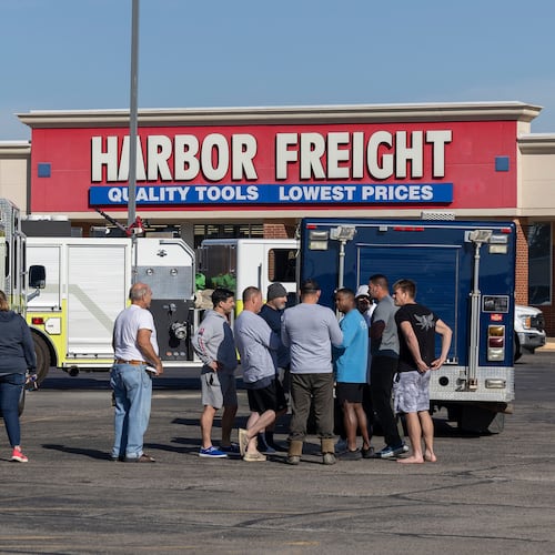 Business owners and first responders gather in a shopping center parking lot near the scene of an ammonia spill in Weatherford, Okla. after the shelter in place was lifted on Thursday, Nov. 13, 2025. (AP Photo/Alonzo Adams)