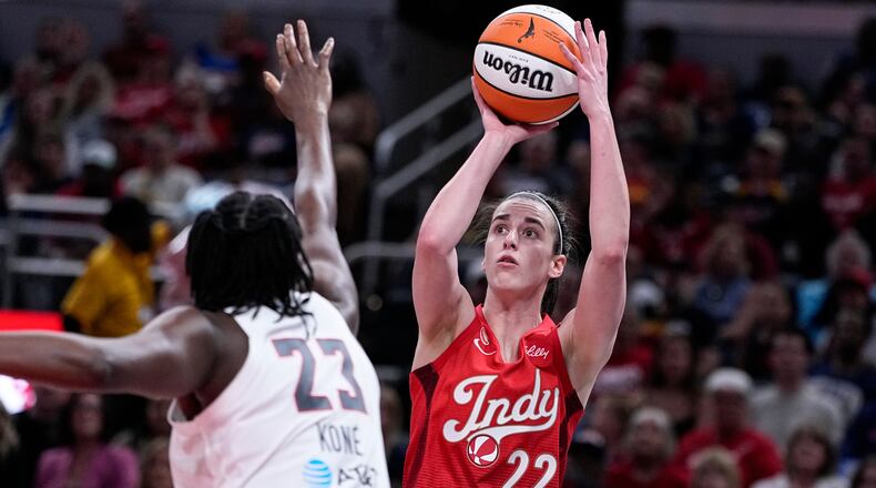 Indiana Fever guard Caitlin Clark (22) shoots over Atlanta Dream forward Sika Kone (23) in the first half of a WNBA basketball game in Indianapolis, Thursday, June 18, 2026. (AP Photo/Michael Conroy)