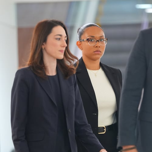 McKenna West, center, walks in a hallway before a court hearing in Dallas, Tuesday, Aug. 25, 2026. (AP Photo/LM Otero)